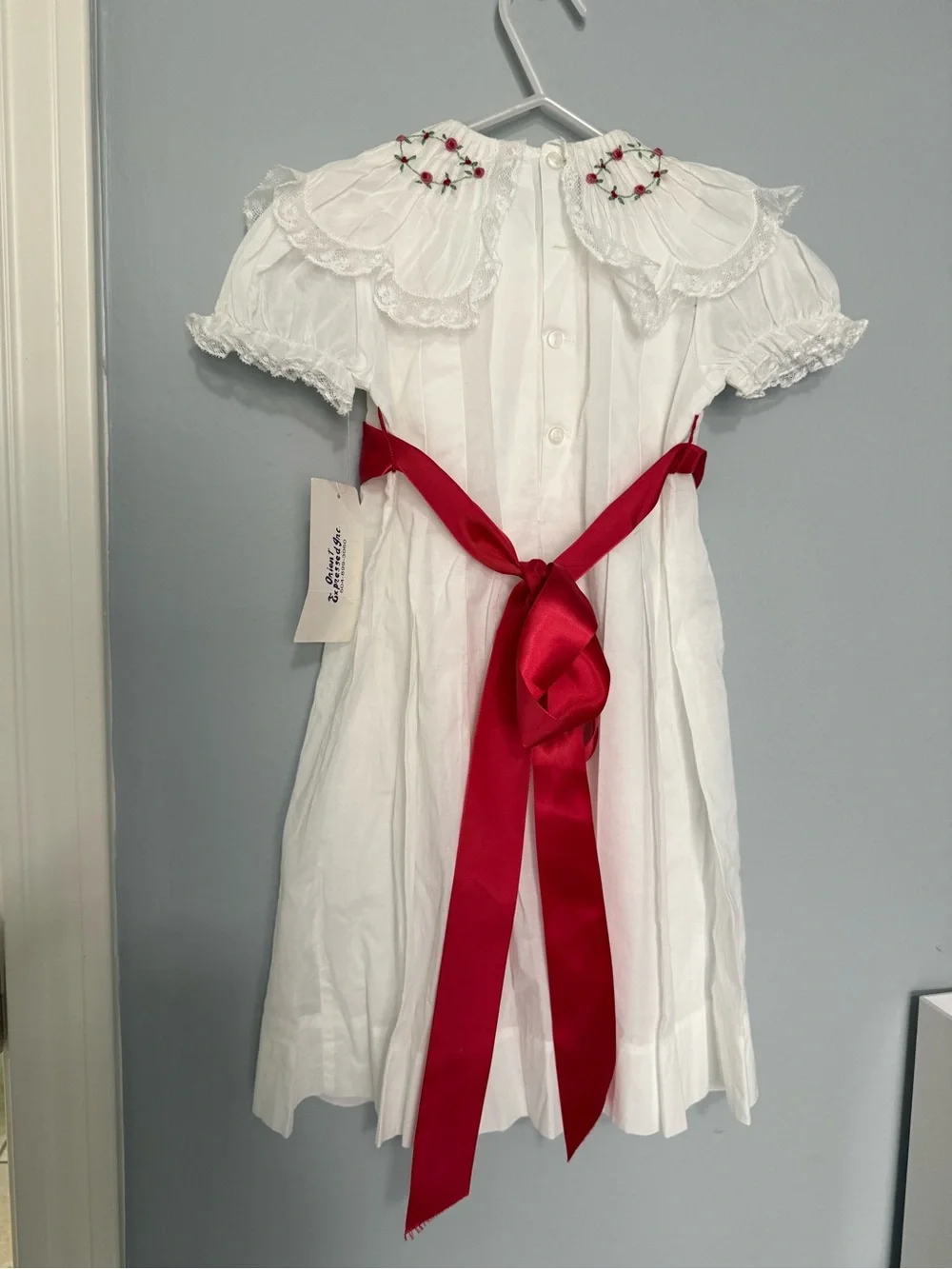 White Smocked Girls' Dress with Red Satin Sash